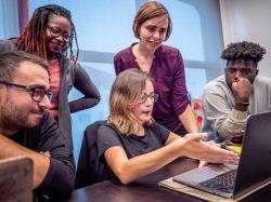 Photo of students working on a laptop